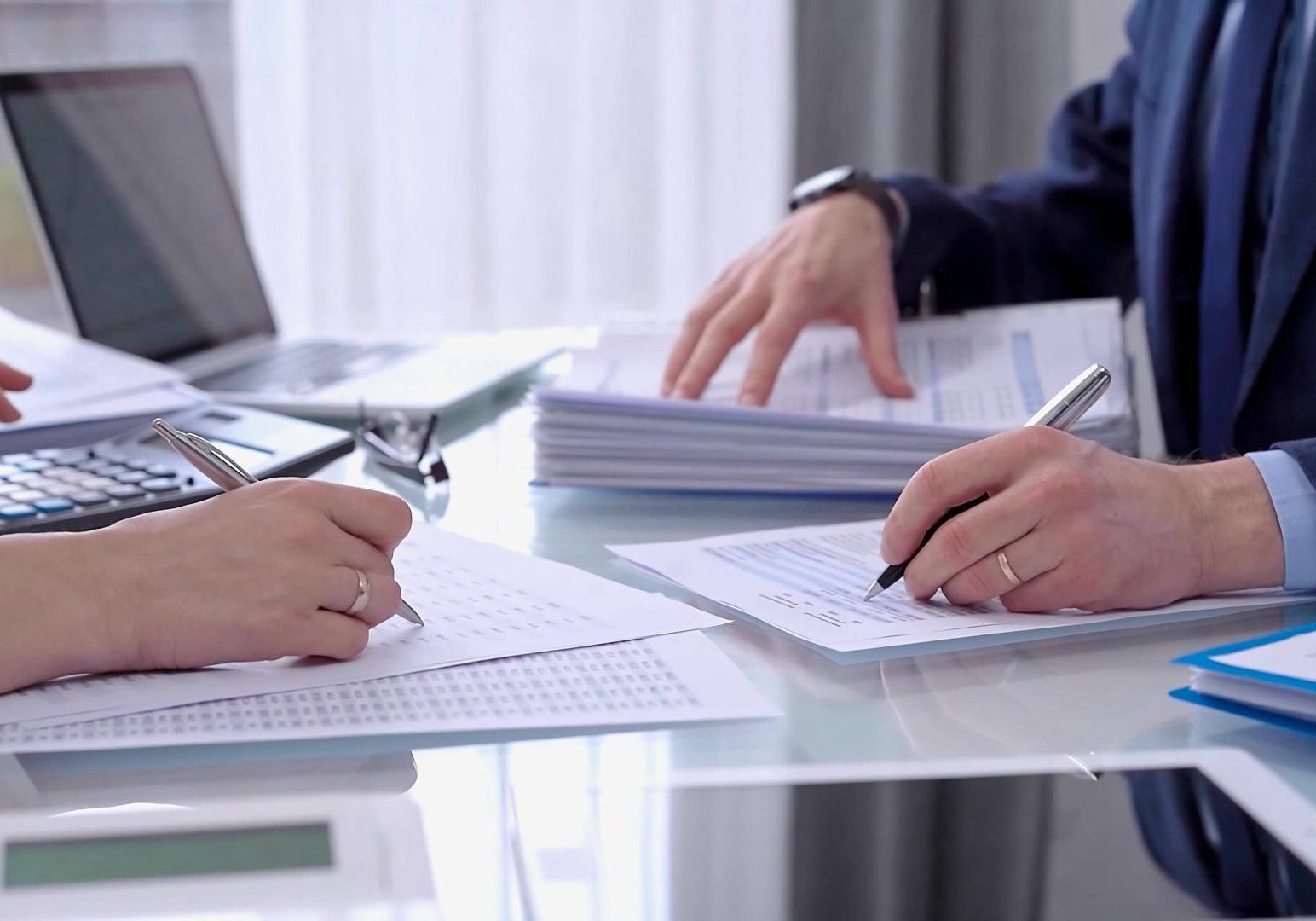 Two people working at a desk.